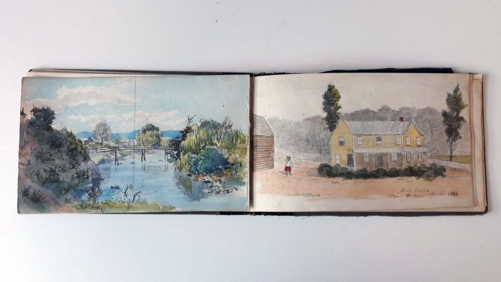 Page 21 (Left): Single page landscape watercolour sketch of an area that Edwin drew multiple times. The image looks out over the Maitai River and wooden bridge. Page 22 (Right): Single page landscape watercolour sketch. A sketch of a yellow, two-storied house with a gable at each end. A figure in a red skirt and a white shirt and a red hat or bow stands holding something on the driveway/road outside. A white picket fence runs behind the house. In the corner of the sketch Edwin has written: ‘Bell Grove April 1886.’