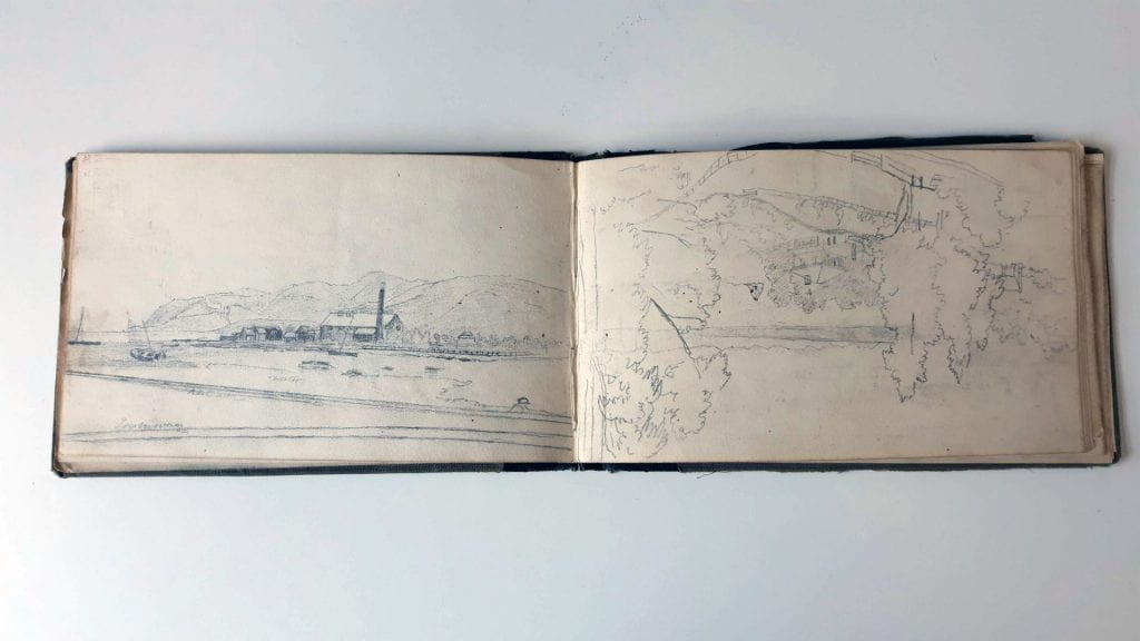 Page 39 (Left): Landscape pencil sketch of a building with tall chimney by the seaside, a boat lying on sand, hill range in background, a road/wall in the foreground with a person’s head popping up above the line. Page 40 (Right): Landscape pencil sketch. Perspective is from a hill, looking down at a house surrounded by some trees, a road going down the hill in the foreground, and a mountain range in the far distance.
