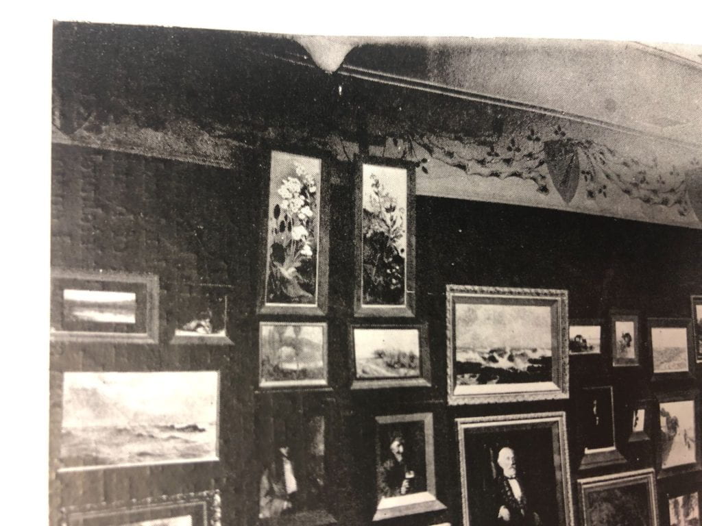 Detail of the New Zealand art gallery photograph, cropped closely to show Emily's two Antarctic panels hanging up high on the wall